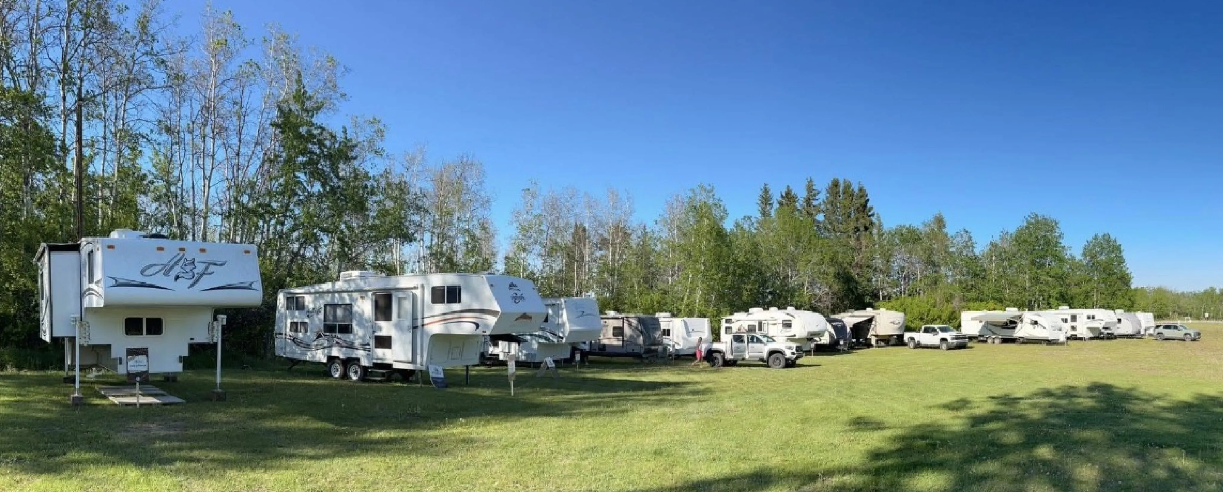 a group of RV all setup for a weekend of camping
