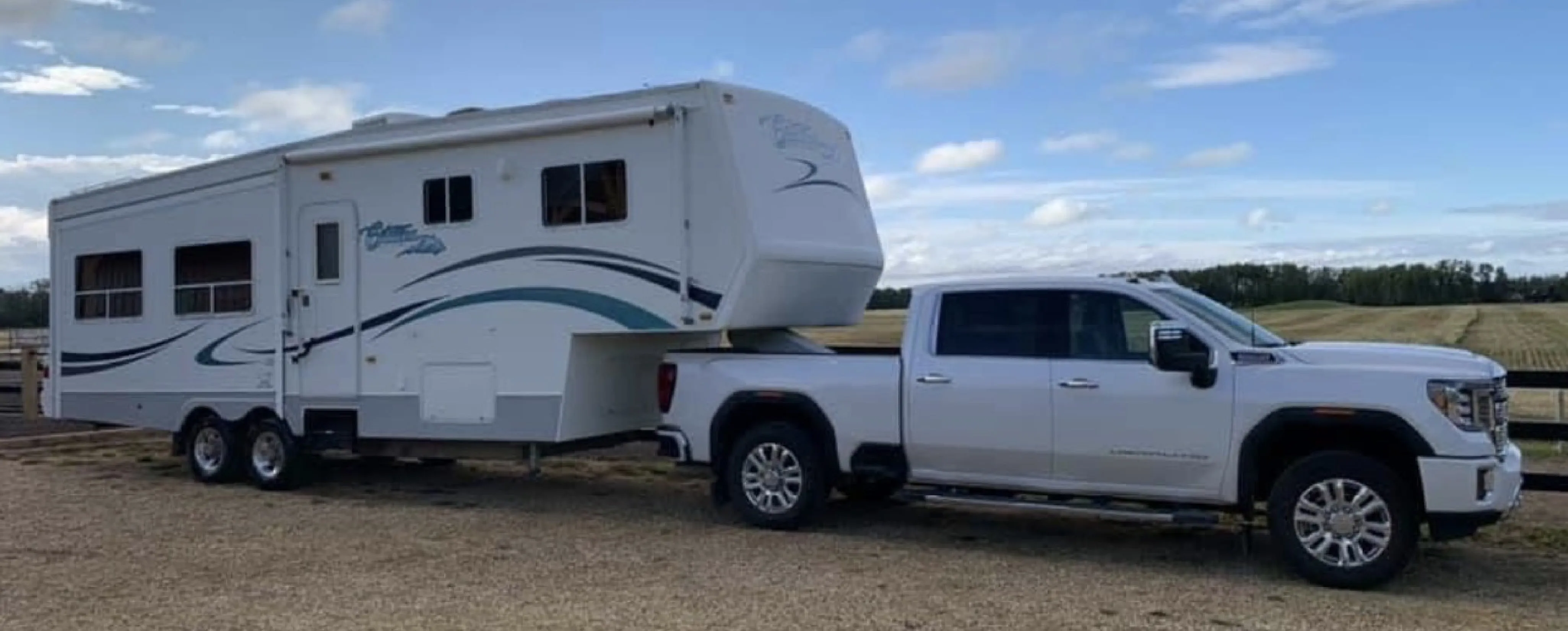 an RV all hooked up to a white truck ready to be hauled to a camp site