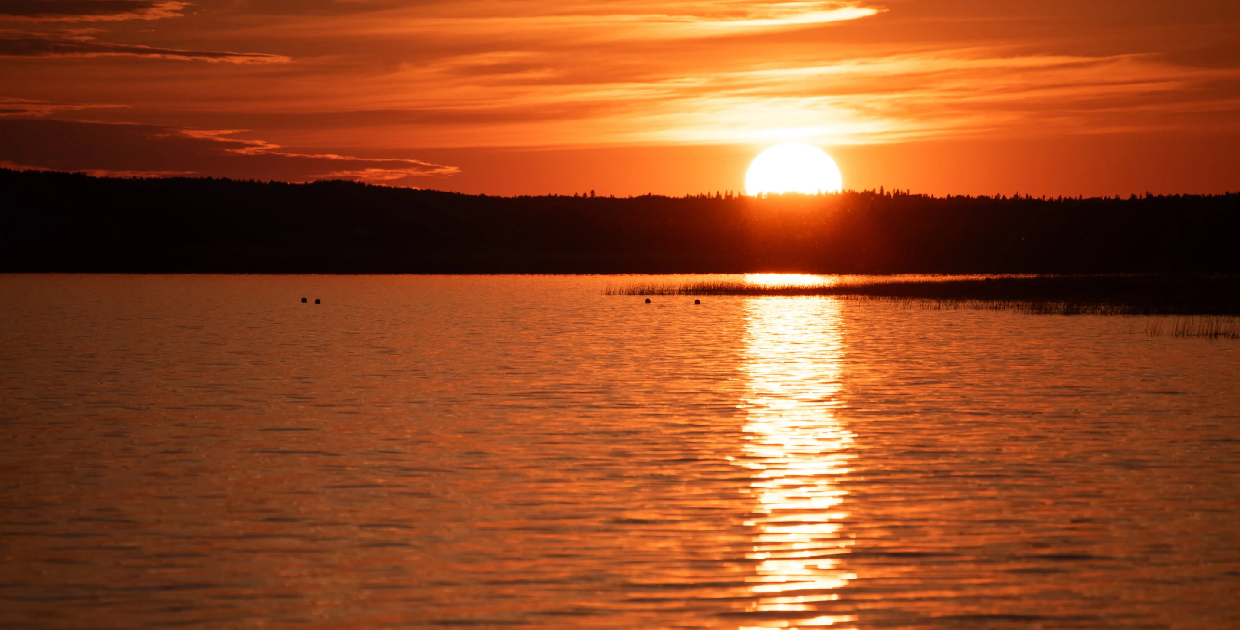 a big sunset over a lake