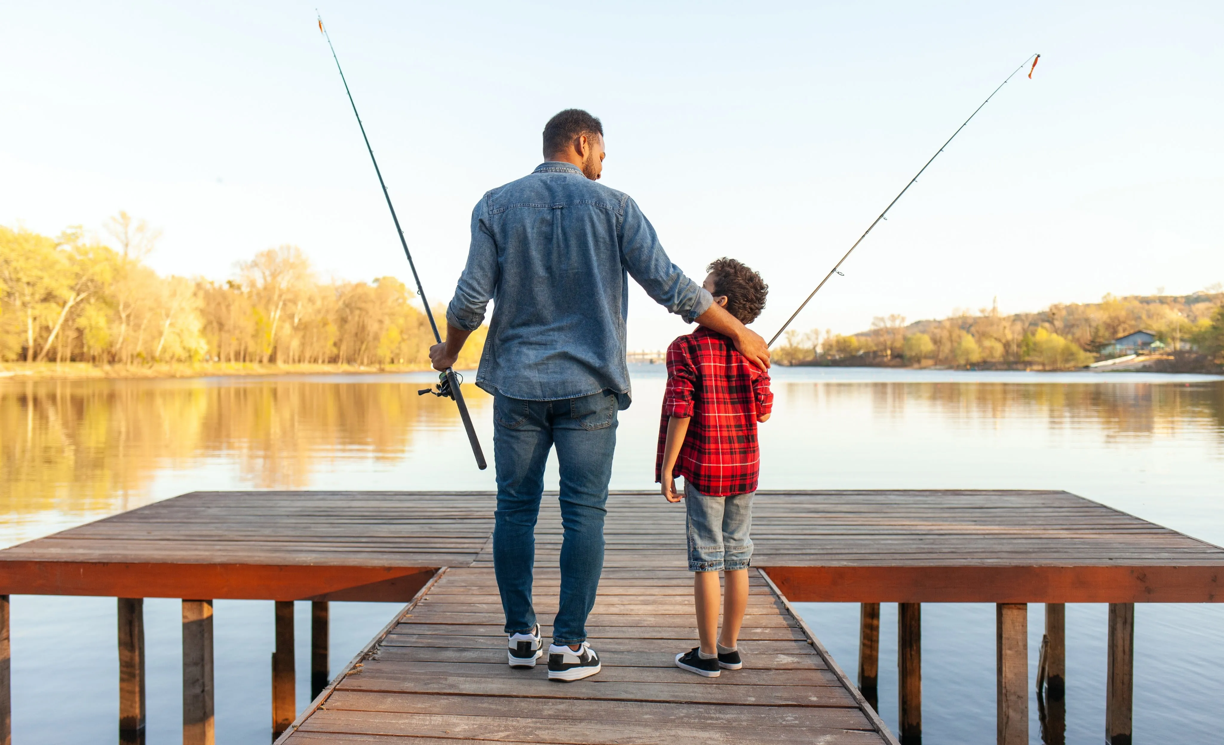 a dad and son getting ready to fish off the end of a dock